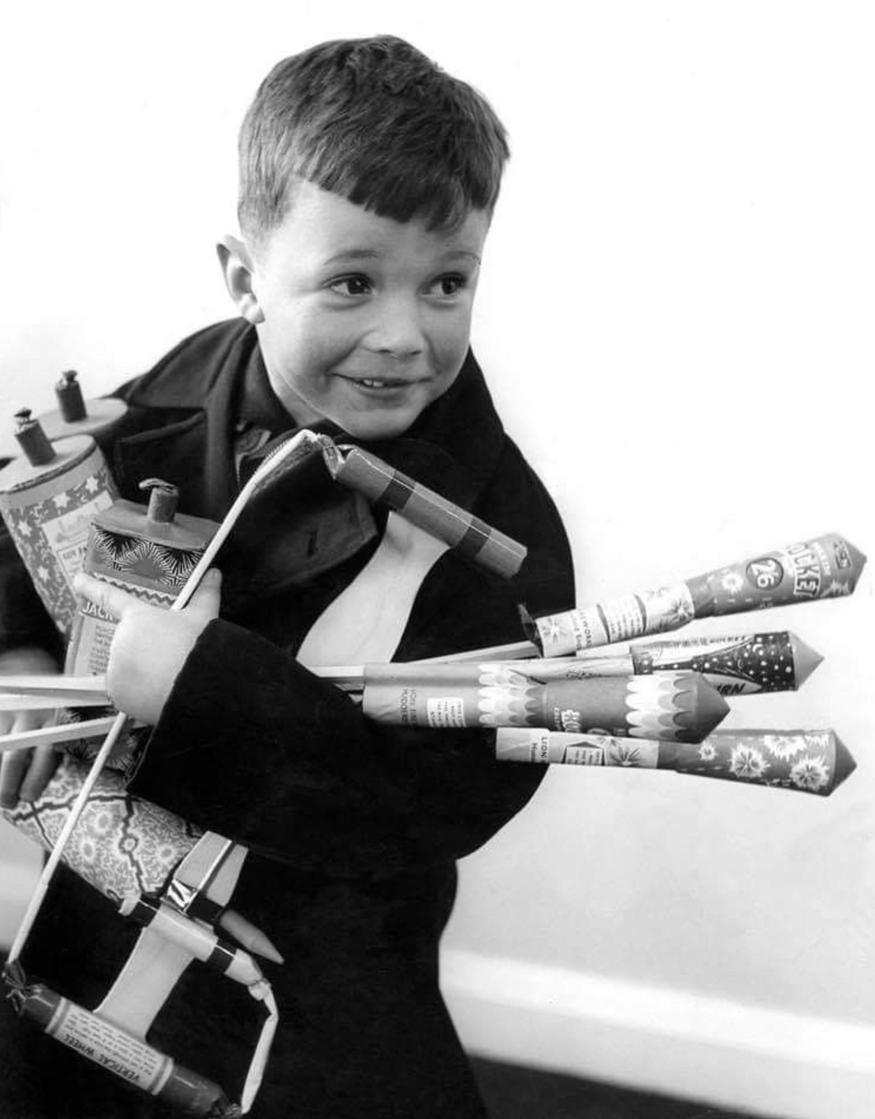 Happily clutching some bottle rockets 